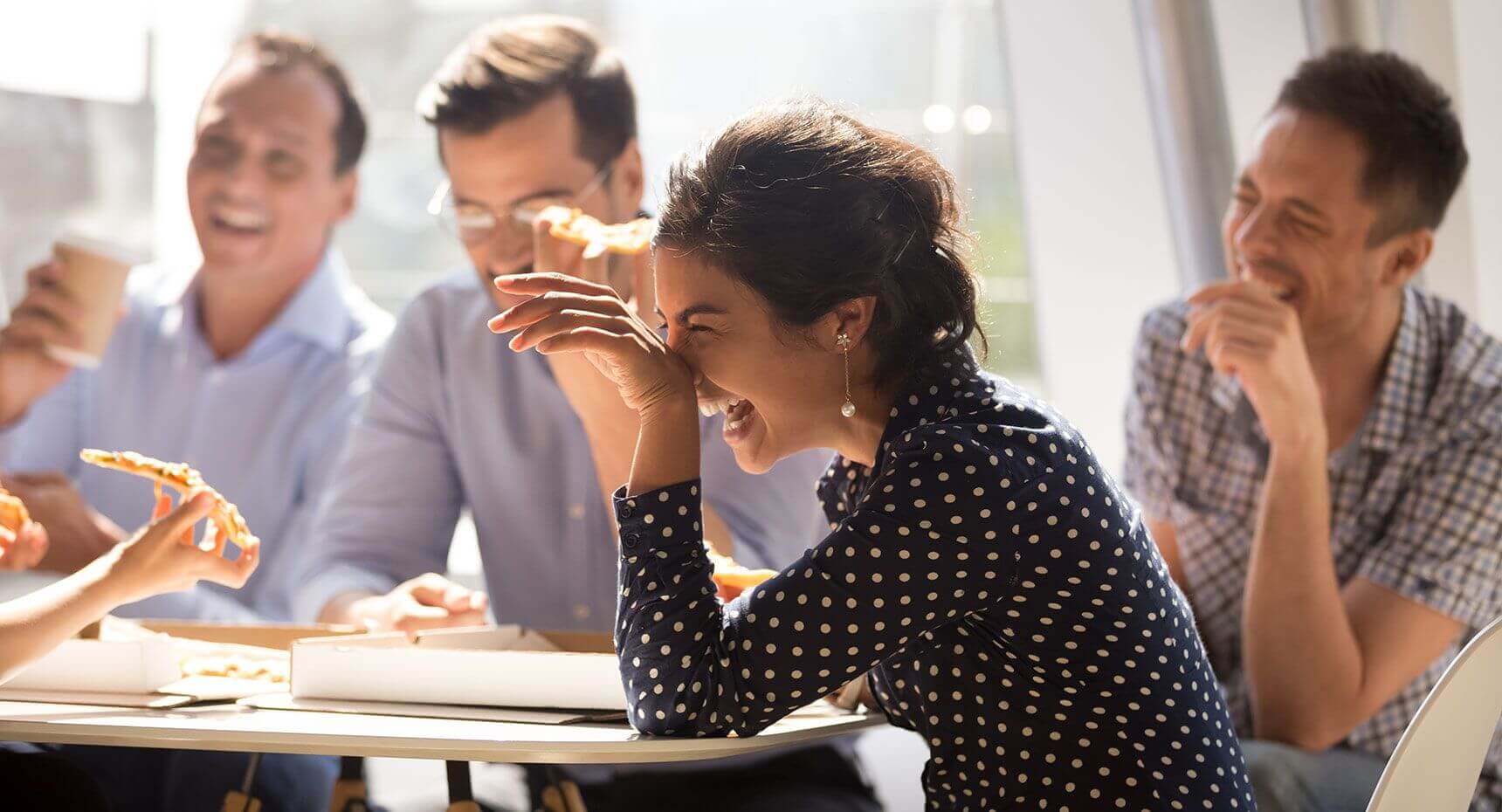 Group of people laughing in a meeting
