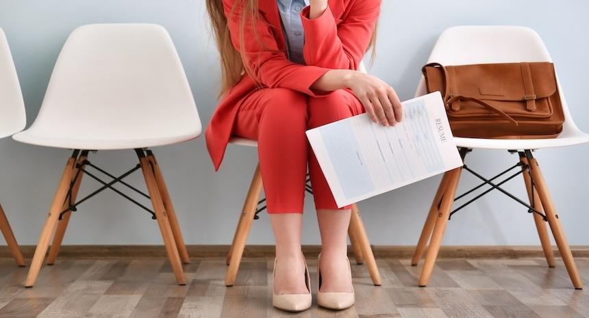 person with one page resume in hand in office waiting room