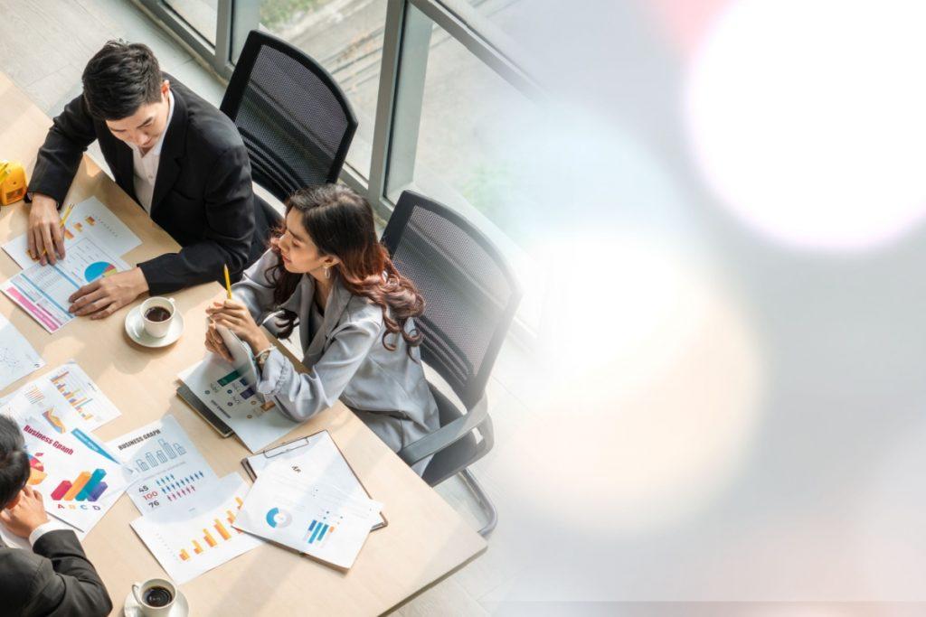 bird eye view of employees working at a meeting table
