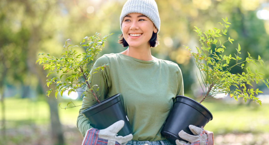 Young woman working on community garden hobby.