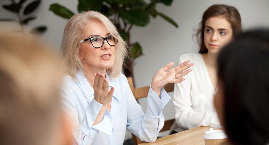 Round table meeting being led by a woman