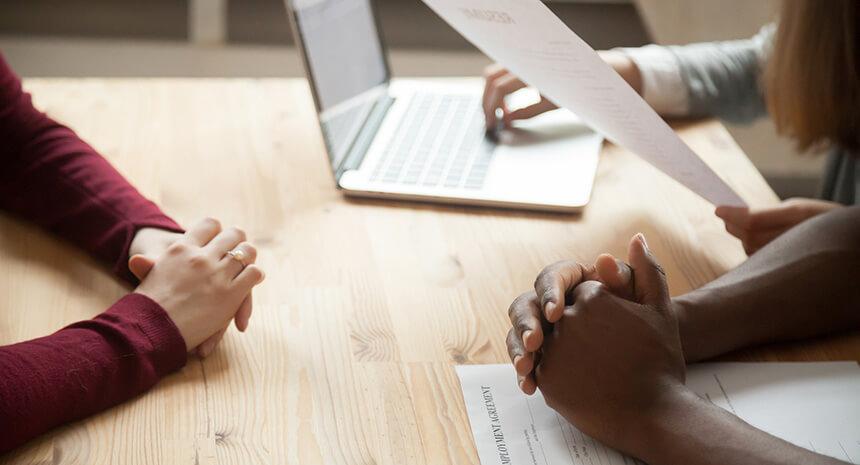 Young woman at a job interview with multiple interviewers
