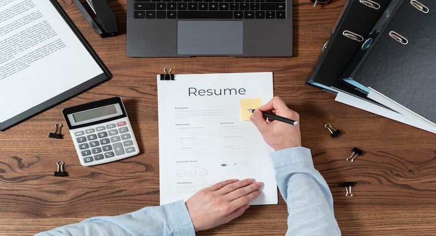 Hiring manager taking notes on a resume