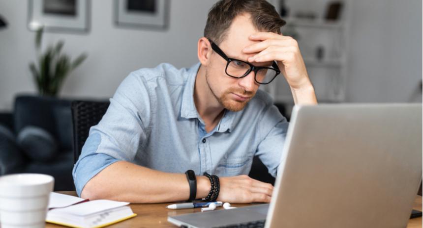Unhappy man looking at a laptop