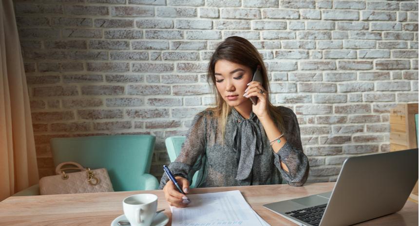 Woman working while sitting in a coffee shop