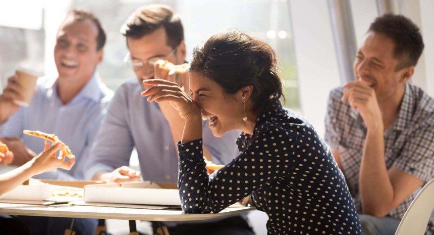 Group of people laughing in a meeting