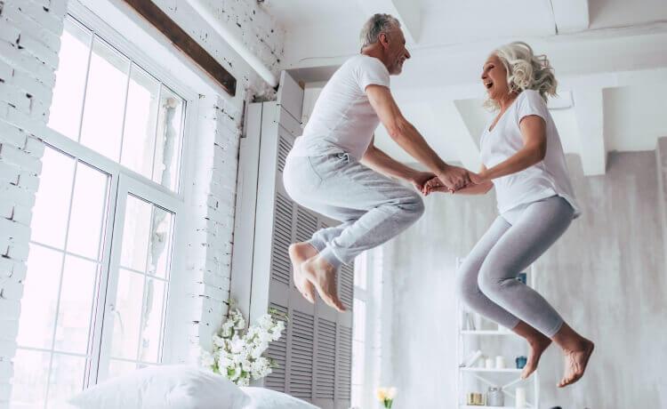 Older couple jumping